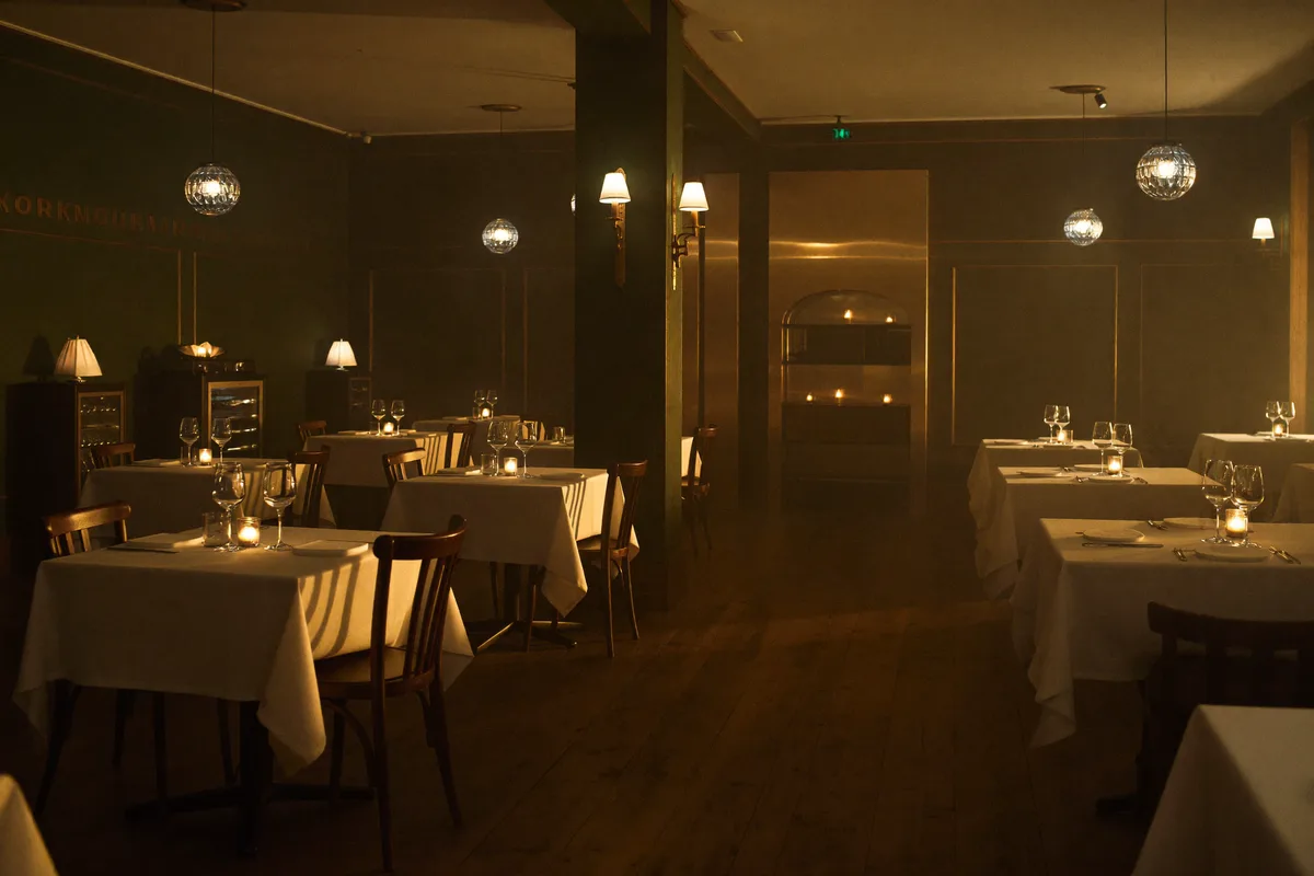 Restaurantraum von NOIR & BASIL im goldenen Abendlicht — eingedeckte Tische und brennende Kerzen kurz vor der Öffnung