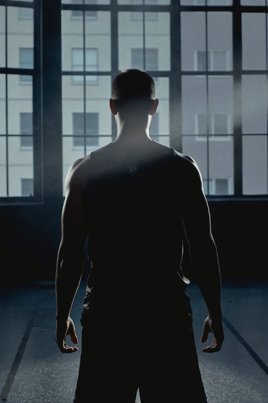 Athleten-Silhouette von hinten vor hellem Studiofenster